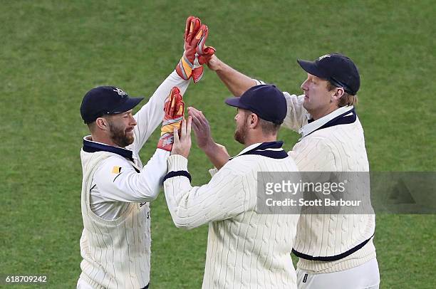 Matthew Wade, Daniel Christian and Cameron White of Victoria celebrate as they win the Sheffield Shield match between Victoria and Tasmania at the...