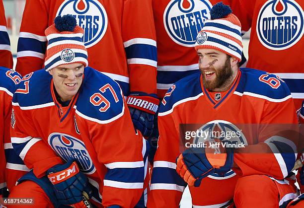 Connor McDavid and Eric Gryba of the Edmonton Oilers share a laugh after practice for the 2016 Tim Hortons NHL Heritage Classic to be played against...