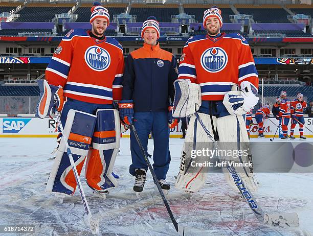 Goaltender coach Dustin Schwartz of the Edmonton Oilers poses with goaltenders Jonas Gustavsson and Cam Talbot after practice for the 2016 Tim...