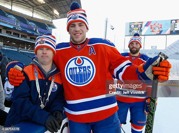 Locker room attendant Joey Moss poses with Milan Lucic of the Edmonton Oilers after practice for the 2016 Tim Hortons NHL Heritage Classic to be...