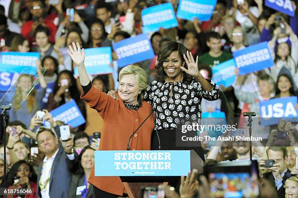 Democratic presidential candidate Hillary Clinton and U.S. First lady Michelle Obama greet supporters during a campaign rally at Wake Forest...