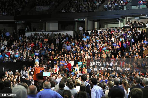 Democratic presidential candidate Hillary Clinton speaks as U.S. First lady Michelle Obama listens during a campaign rally at Wake Forest University...