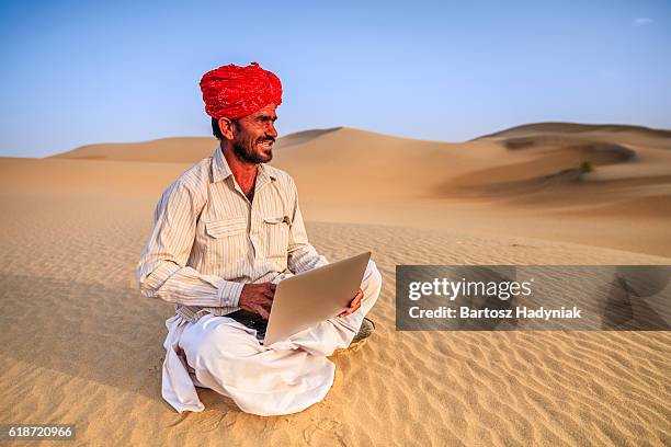 indian man using a laptop, desert village, india - laptop desert stock pictures, royalty-free photos & images