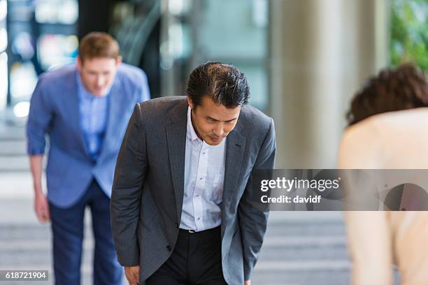 group of business people meeting in japan - bowing stock pictures, royalty-free photos & images