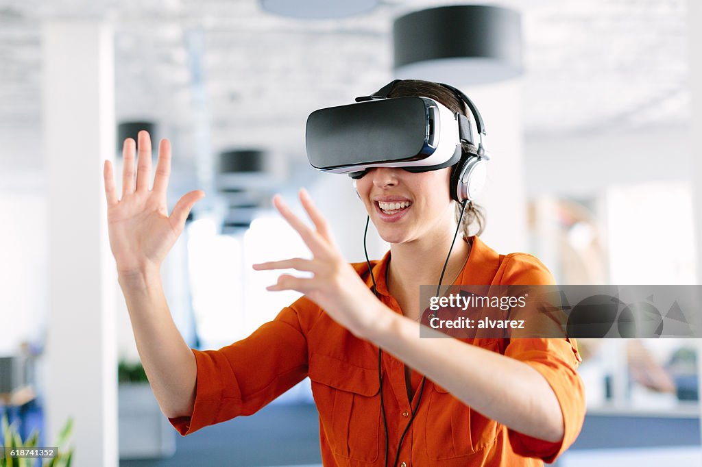 Woman using virtual reality simulator headset