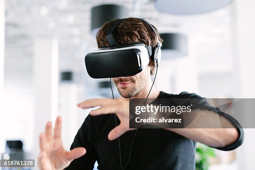 Man using virtual reality simulator headset Man using virtual reality simulator headset
