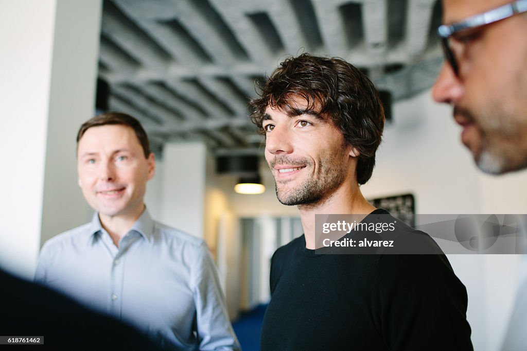 Man standing with colleagues at startup