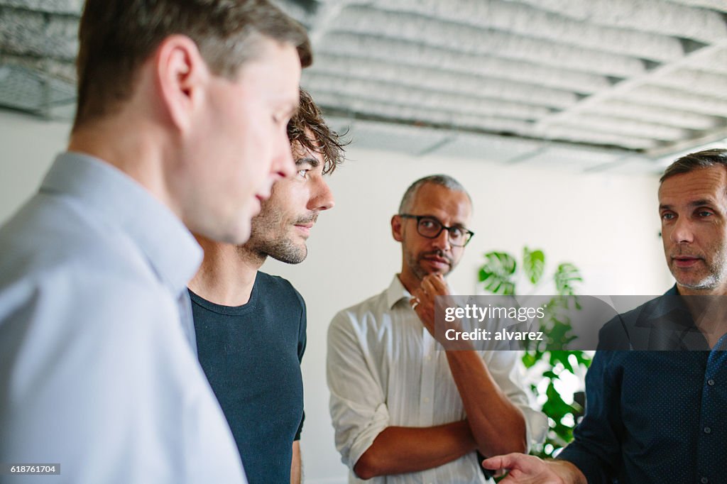 Businesspeople having a standing meeting in office