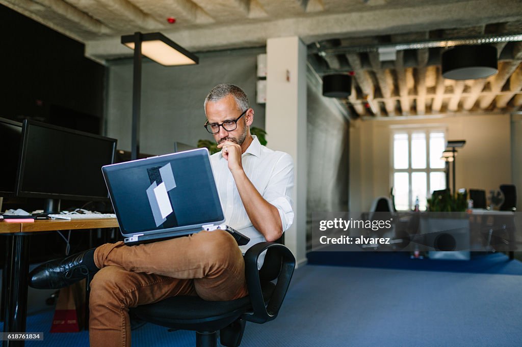 Businessman busy working on laptop