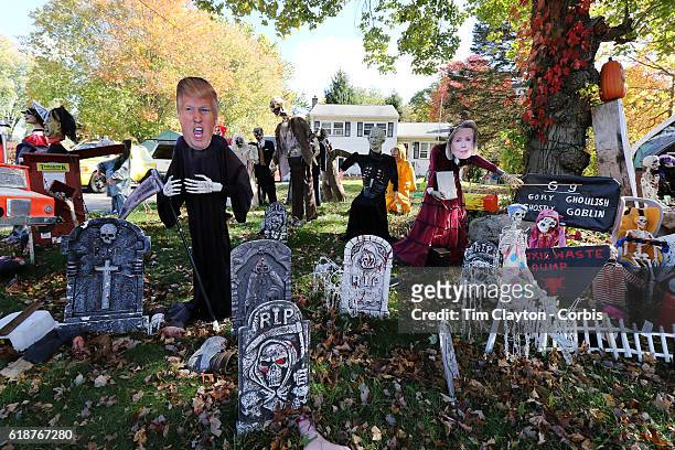 Donald Trump depicted as the Grim Reaper and Hilary Clinton make up a Halloween scene combining the season and the upcoming presidential election in...