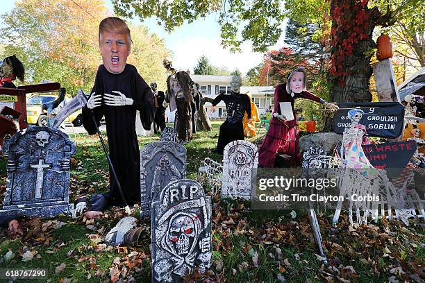 Donald Trump depicted as the Grim Reaper and Hilary Clinton make up a Halloween scene combining the season and the upcoming presidential election in...