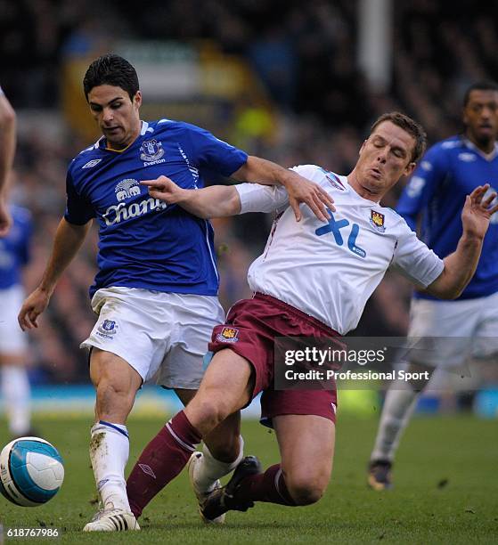 Mikel Arteta of Everton battles with Scott Parker of West Ham during the Barclays Premier League match between Everton and West Ham United at...