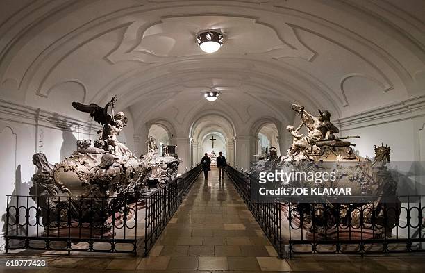 People walk between tombs of some of 149 members of the Habsburg dynasty at the Imperial Crypt in Vienna, Austria on October 19, 2016. Their hearts...