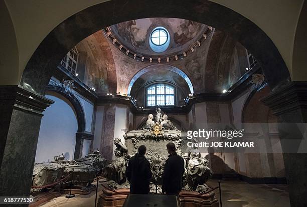 People look at the Tomb of Empress Maria Theresa of Austria one of 149 members of the Habsburg dynasty at the Imperial Crypt in Vienna, Austria on...