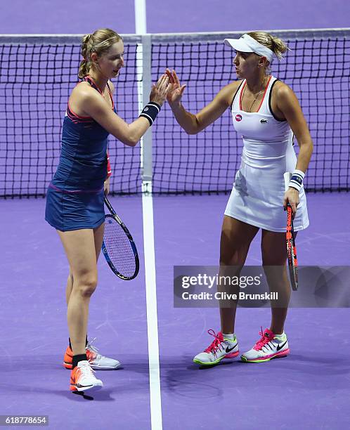 Elena Vesnina and Ekaterina Makarova of Russia celebrate a point in their doubles match against Andrea Hlavackova and Lucie Hradecka of Czech...