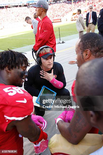 Outside Linebackers Coach Jason Tarver of the San Francisco 49ers goes over game images with the linebackers during the game against the Tampa Bay...