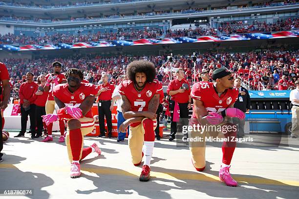 Eli Harold, Colin Kaepernick and Eric Reid of the San Francisco 49ers kneel for the anthem prior to the game against the Tampa Bay Buccaneers at Levi...