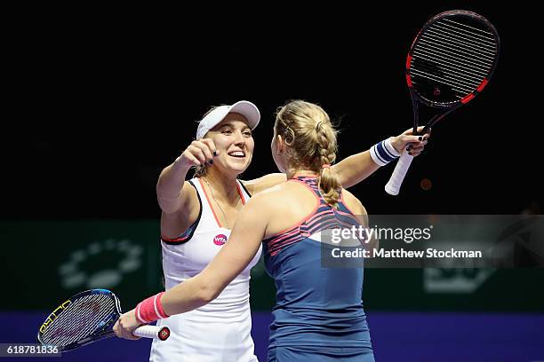 Elena Vesnina and Ekaterina Makarova of Russia celebrate victory in their doubles match against Andrea Hlavackova and Lucie Hradecka of Czech...