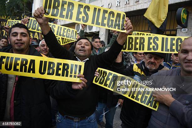 Taxi drivers demonstrate during a protest against US multinational online transportation network company Uber, in Buenos Aires on October 28, 2016. A...