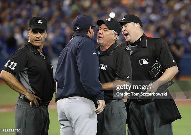 Home plate umpire Todd Tichenor argues with bench coach Rob Thomson of the New York Yankees after Thomson was ejected as first base umpire Tom...