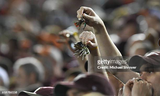 Fans of the Virginia Tech Hokies shake their keys during a "Key Play" third down against the Miami Hurricanes in the second half at Lane Stadium on...