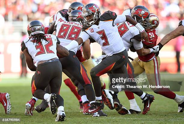 Jameis Winston of the Tampa Bay Buccaneers turns to hand the ball off to running back Jacquizz Rodgers against the San Francisco 49ers during the...