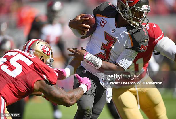 Jameis Winston of the Tampa Bay Buccaneers runs with the ball and gets tackled by Ahmad Brooks and Arik Armstead of the San Francisco 49ers during...