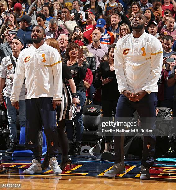 Kyrie Irving and LeBron James of the Cleveland Cavaliers watch the championship banner being raised before the game against the New York Knicks on...