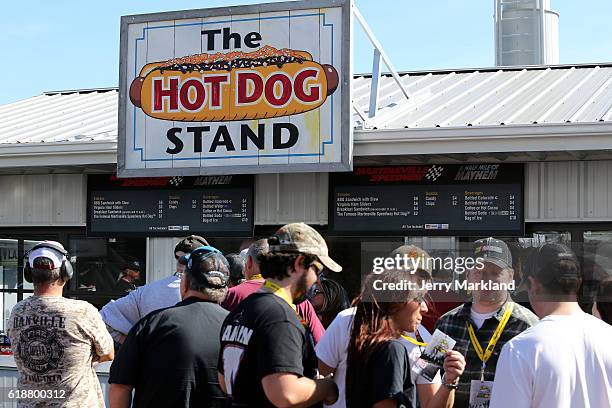 Fans wait in line at a hot dog concession stand during practice for the NASCAR Camping World Truck Series Texas Roadhouse 200 presented by Alpha...
