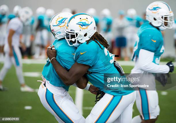 Miami Dolphins Cornerback Tyler Patmon and Miami Dolphins Cornerback Ifo Ekpre-Olomu practice a blocking drill during a practice session at the...