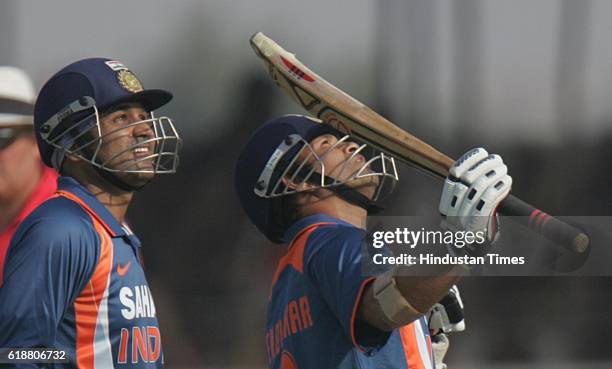 Cricket - India vs Sri Lanka ODI - India batsman Sachin Tendulkar raises his bat after half century as Virendra Sehwag congratulates him during the...