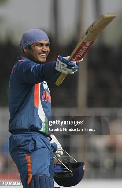 Cricket - India vs Sri Lanka ODI - India batsman Virendra Sehwag celebrates his century during the first ODI between India and Sri Lanka at Madhavrao...