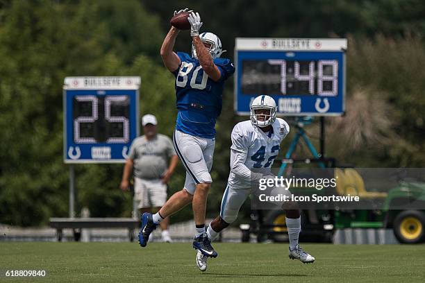 Indianapolis Colts tight end Chase Coffman catches a pass in front of Indianapolis Colts safety Stefan McClure during NFL training camp practice at...