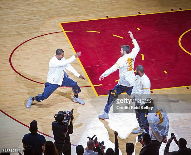 Smith and Kevin Love of the Cleveland Cavaliers high five before the game against the New York Knicks on October 25, 2016 at Quicken Loans Arena in...