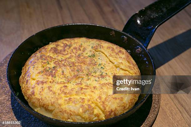 traditional spanish omelette, tortilla in a classic casting iron pan, tapas - iron wine stock pictures, royalty-free photos & images