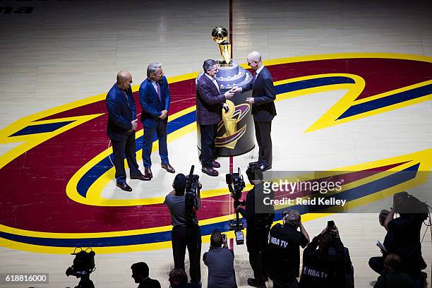 Commissioner, Adam Silver presents the Owner of the Cleveland Cavaliers, Dan Gilbert with his championship ring before the game against the New York...