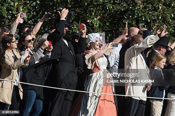 Abraham Lincoln and Abigail Adams impersonators watch Marine One carrying US President Barack Obama take off from the White House in Washington, DC,...