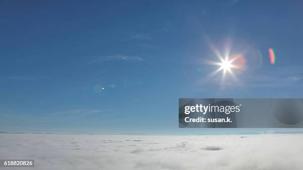 sea of fog on clear blue sky and bright sunlight - mezzogiorno foto e immagini stock