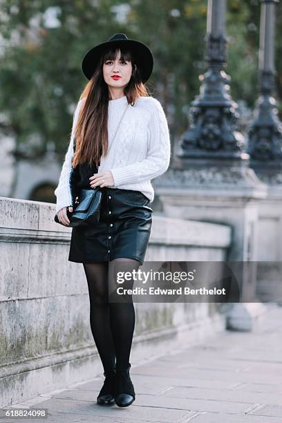 Nikita Wong , is wearing a black hat, an IKKS black and white pull over, a Les Petites black skirt, a Vivienne Westwood bag, and Oui Gal black shoes,...