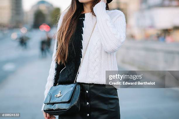 Nikita Wong , is wearing a black hat, an IKKS black and white pull over, a Les Petites black skirt, a Vivienne Westwood bag, and Oui Gal black shoes,...