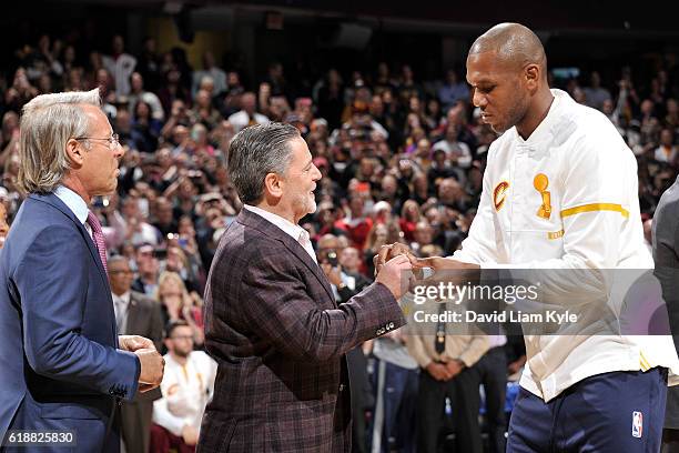 Owner, Dan Gilbert presents James Jones of the Cleveland Cavaliers with his championship ring before the game against the New York Knicks on October...