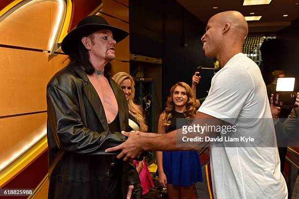 Wrestler, The Undertaker shakes hands with Richard Jefferson of the Cleveland Cavaliers before the game against the New York Knicks on October 25,...