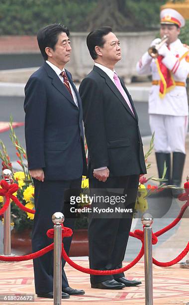 Vietnam - Japanese Prime Minister Shinzo Abe and his Vietnamese counterpart Nguyen Tan Dung attend a welcoming ceremony for Abe in Hanoi on Jan. 16,...