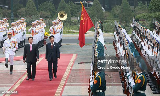 Vietnam - Japanese Prime Minister Shinzo Abe is escorted by his Vietnamese counterpart Nguyen Tan Dung during a welcoming ceremony for Abe in Hanoi...