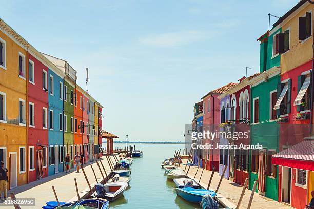 traditional colored houses on canal at burano, venice (italy) - burano foto e immagini stock