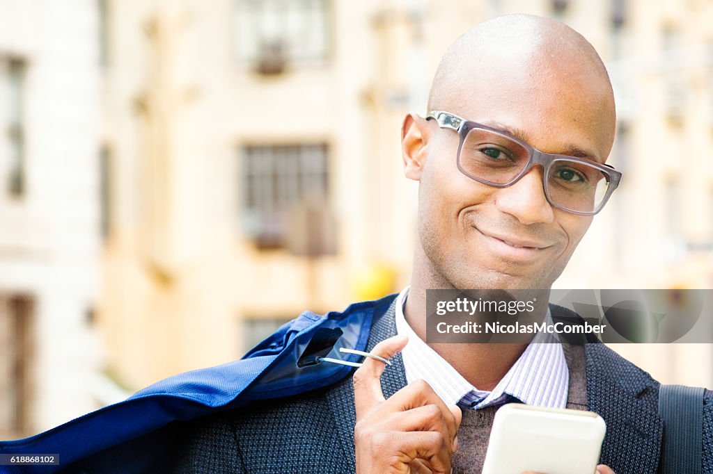 Mature businessman urban portrait with dry cleaning and phone