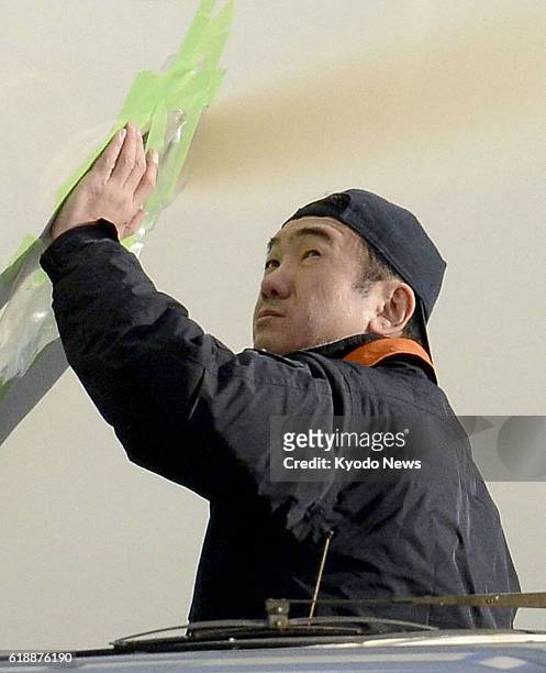 Japan - A Japanese aviation expert at Takamatsu Airport examines traces of smoke on the left side of an All Nippon Airways Co. Boeing 787 Dreamliner...