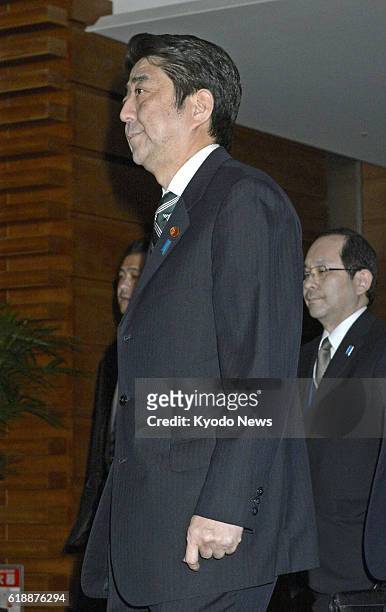 Japan - Prime Minister Shinzo Abe leaves his office in Tokyo on Jan. 21 after attending a meeting of the government's task force on a hostage crisis...