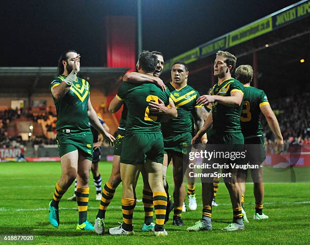 Australia's Josh Mansour celebrates scoring his sides fifth try with team-mates during the Four Nations match between the Australian Kangaroos and...