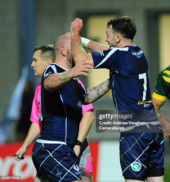 Scotland's Ryan Brierley, right, celebrates scoring his sides first try with team-mate Lewis Tierney during the Four Nations match between the...